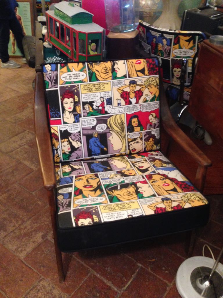 antiquariato: Wooden armchair with cartoon fabric comic seat